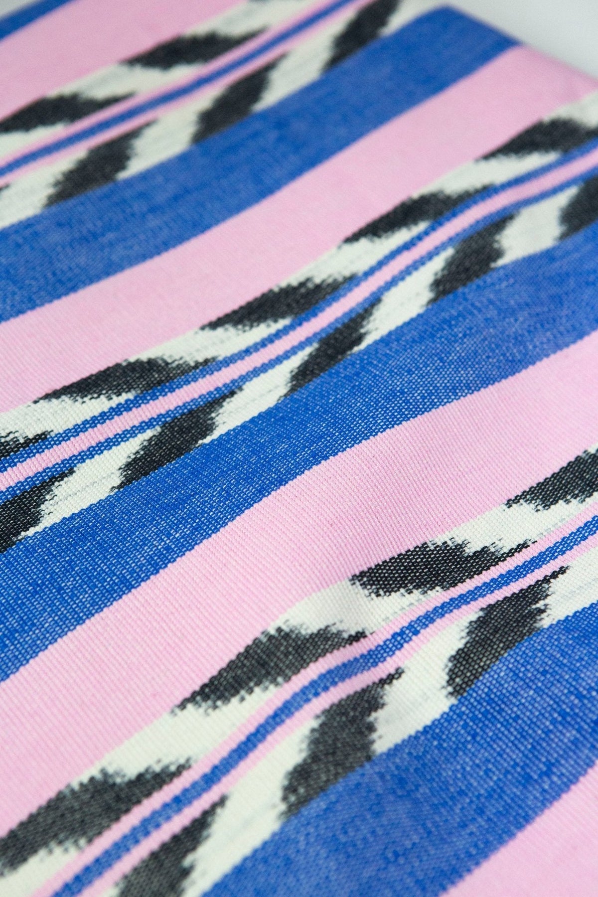 Close-up of the hand-dyed palm ikat pattern in blue and pink