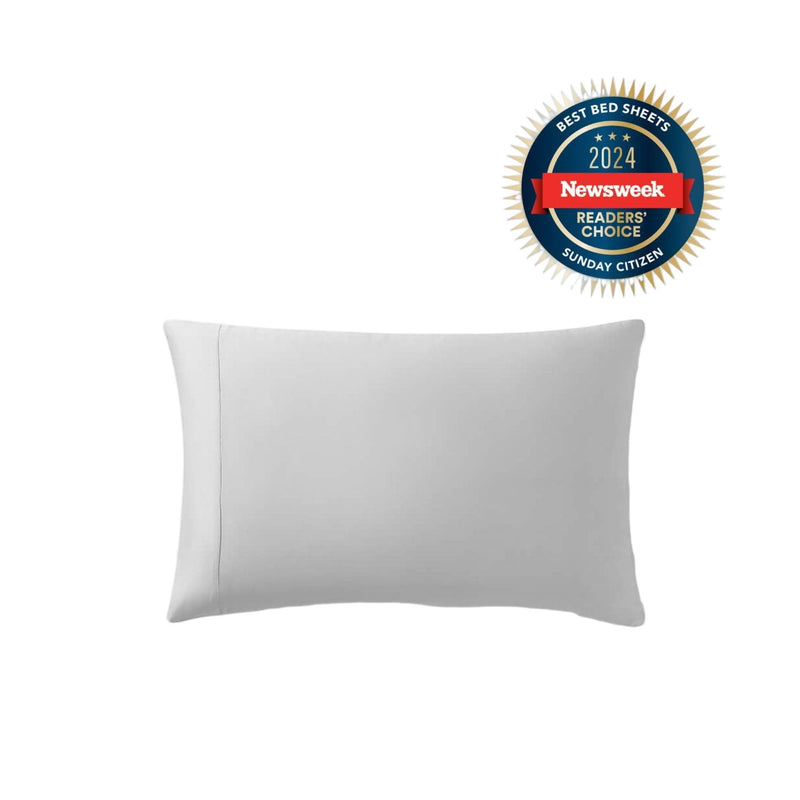 Silky Lyocell pillowcase set in white folded on bed
