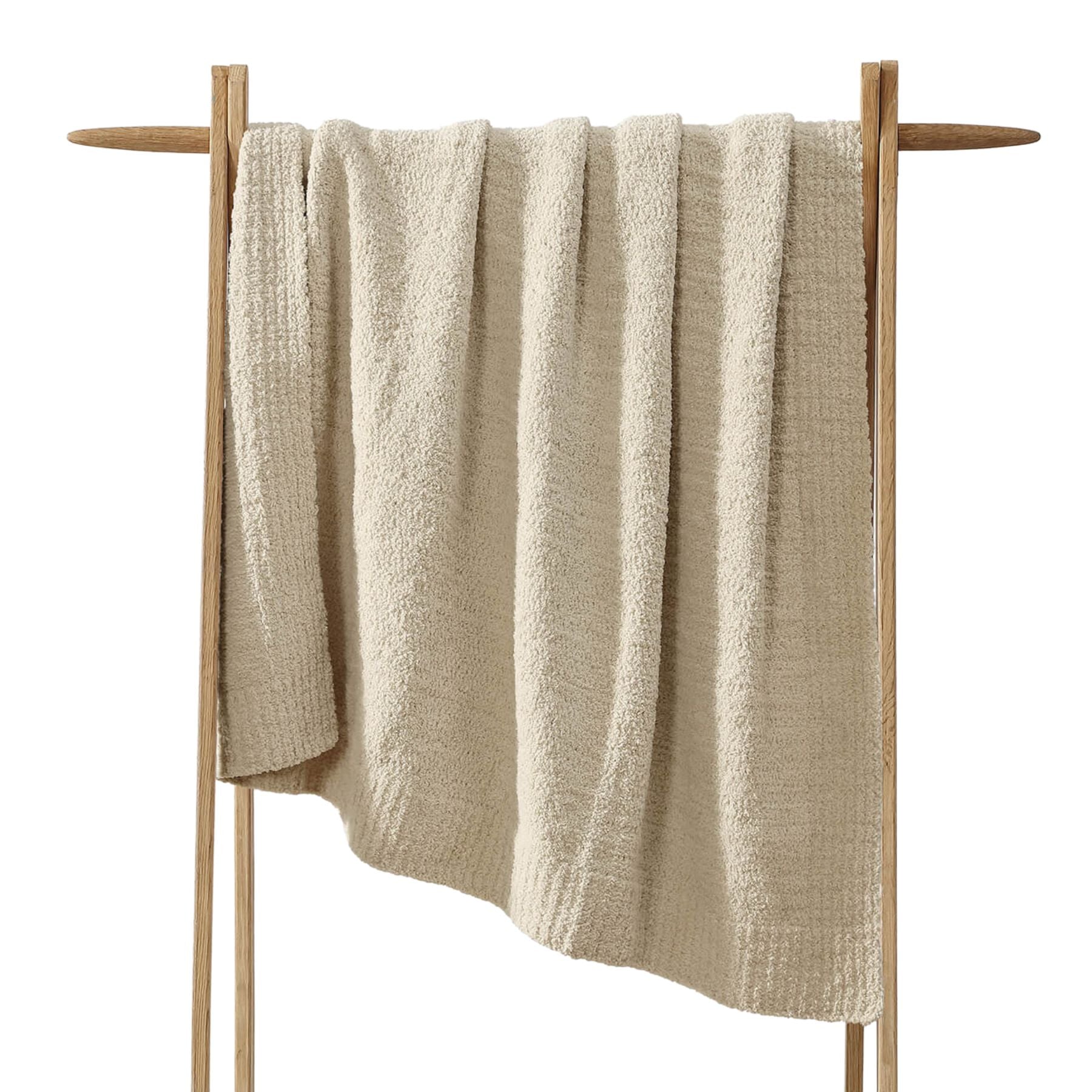 Snug Lap Throw folded on armchair in neutral color