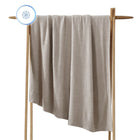 Oversized Cloud Cool Throw draped across a sofa