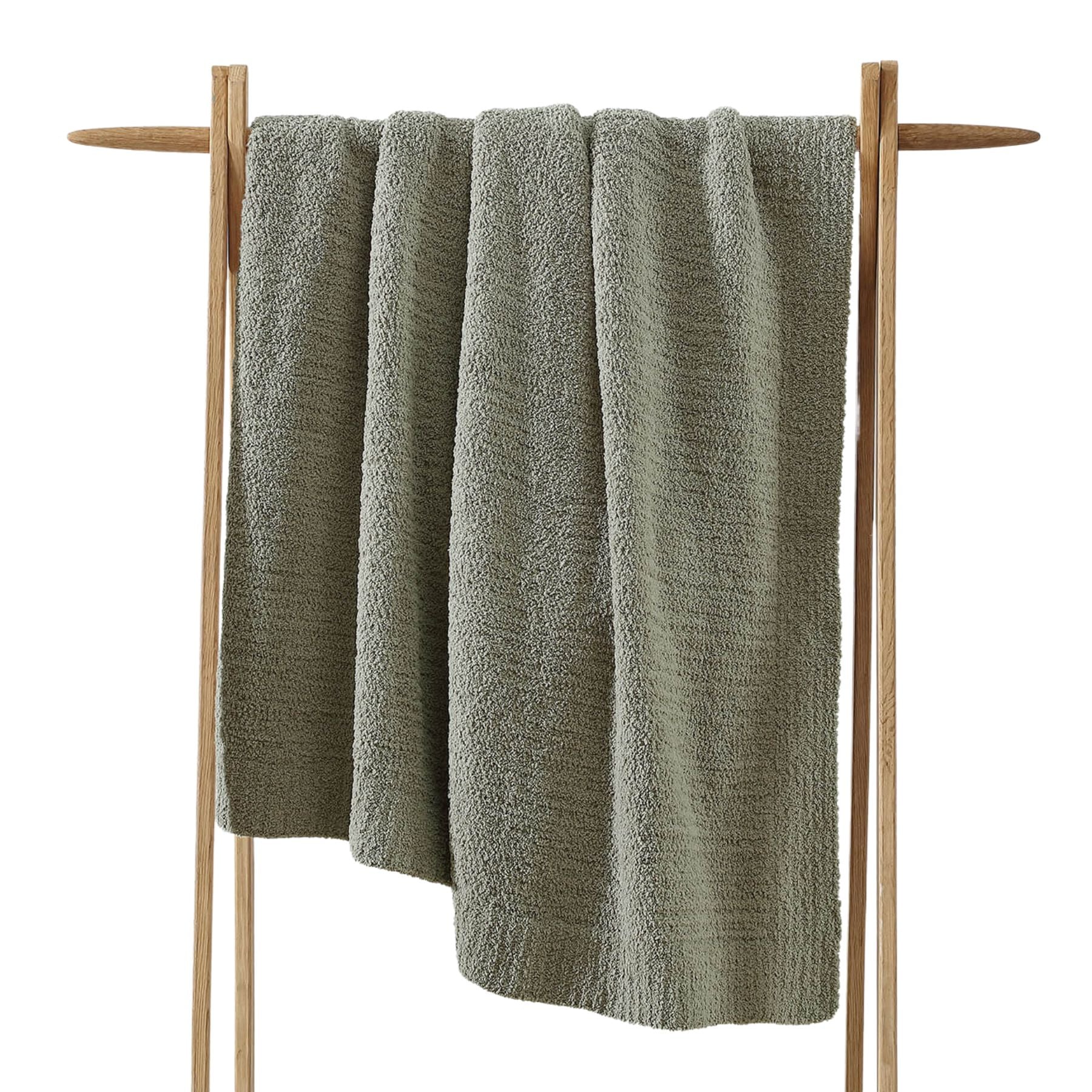 Snug Throw blanket draped over a sofa in neutral tones