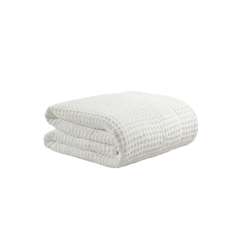 Snug Waffle Comforter folded on bed in soft neutral color