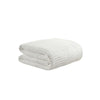Snug Waffle Comforter folded on bed in soft neutral color
