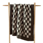 Checkerboard Snug Throw draped over sofa arm