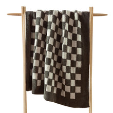 Checkerboard Snug Throw draped over sofa arm