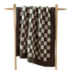 Checkerboard Snug Throw draped over sofa arm