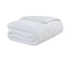 Snug Stitch Comforter styled on modern bed with stitched pattern