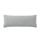 Snug Waffle Lumbar Pillow styled on bed with layered bedding