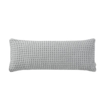 Snug Waffle Lumbar Pillow styled on bed with layered bedding