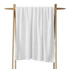 Cloud Silque Throw draped over a neutral-toned sofa