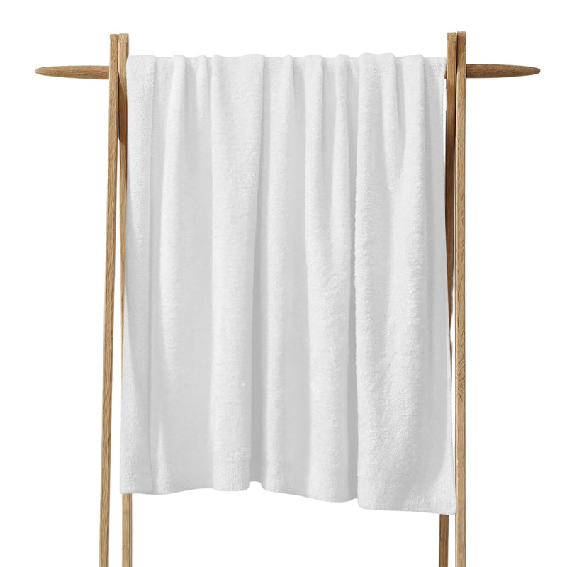 Cloud Silque Throw draped over a neutral-toned sofa