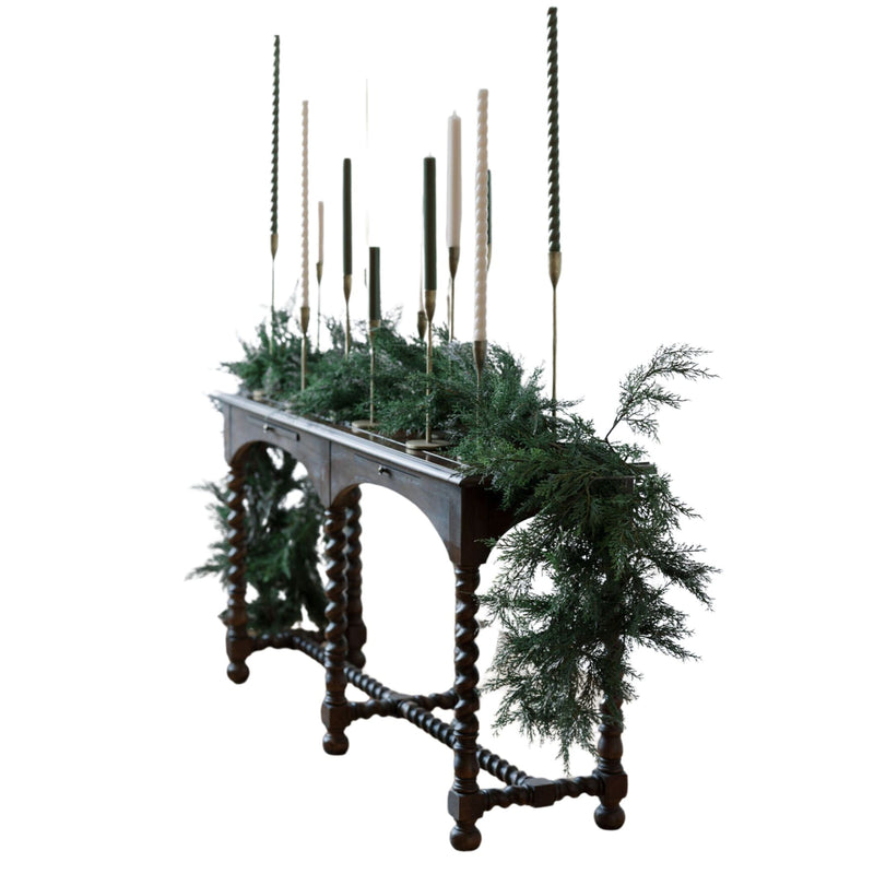 Lifelike faux cedar garland on staircase railing