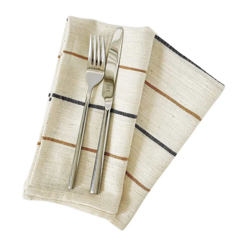 Set of two Sabahar Adama handwoven cotton napkins folded on dining table