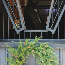 Fresh-looking faux pine wreath with pinecone accents