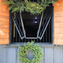 Elegant artificial Christmas wreath with lifelike pinecones
