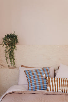 Antigua pillow in umber brown styled in the Witness Apartment interior