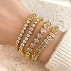 Gold Bezel Heart Tennis Bracelet stacked with other bangles