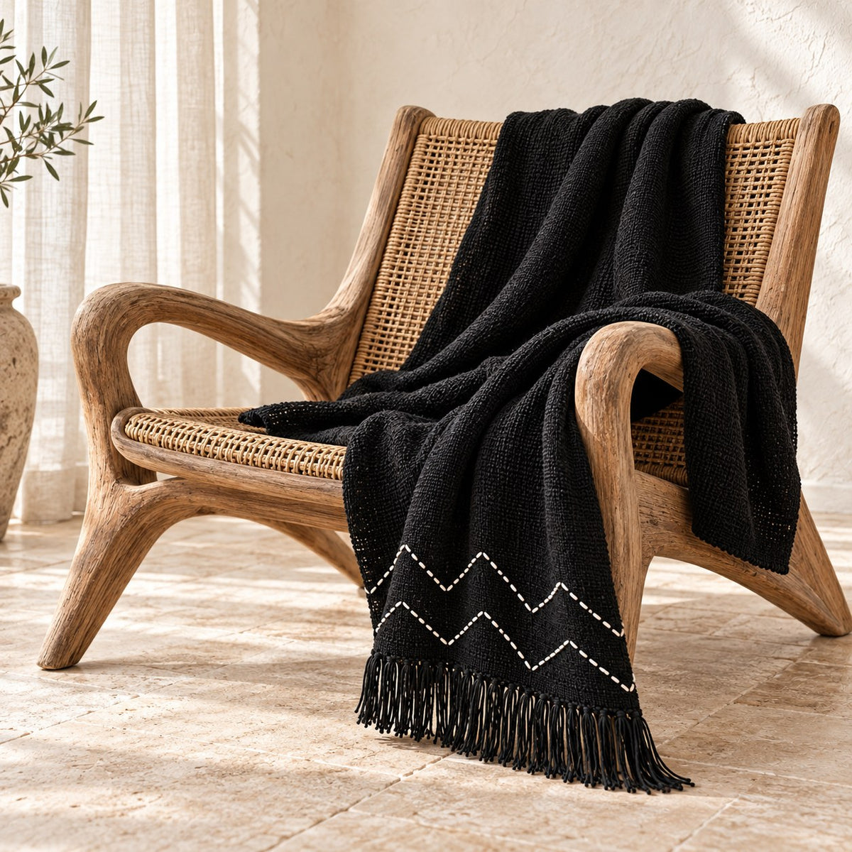 Black chevron cotton throw draped over an accent chair
