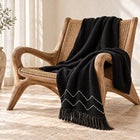Black chevron cotton throw draped over an accent chair