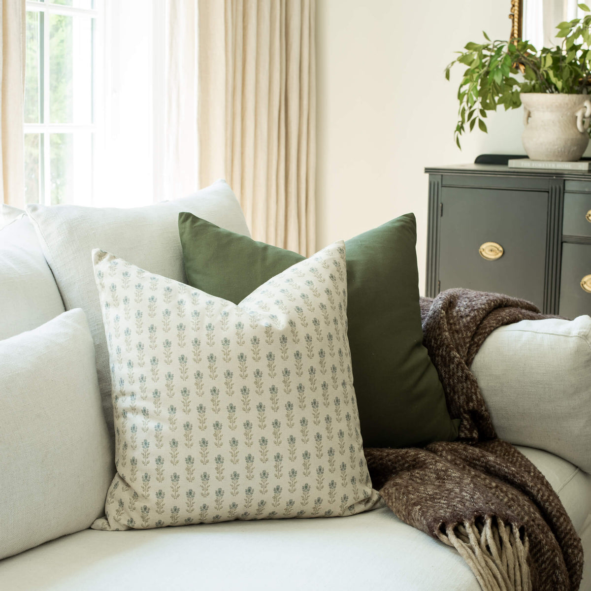 Stella blue floral throw pillow cover on a neutral sofa