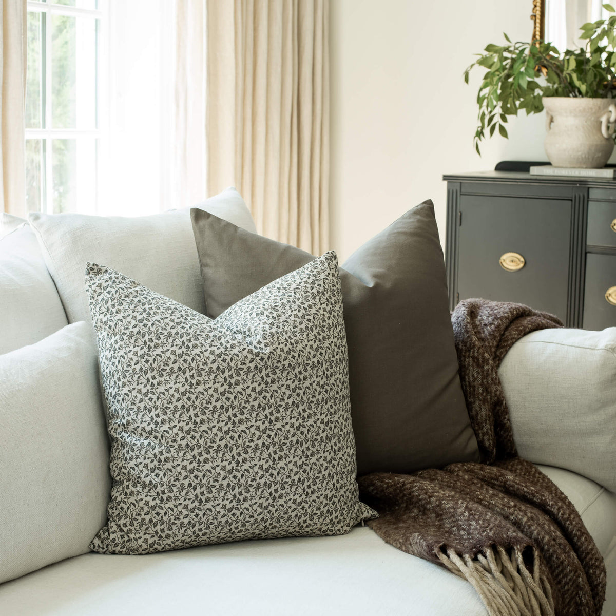 Camille ditsy floral throw pillow cover on a sofa
