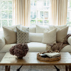 Stella blue floral pillow with ivory pillows in a bright living room