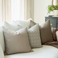 Sonoma set with brown gingham and botanical pillows on a sofa