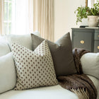 Pippa brown ditsy block print throw pillow cover on a sofa