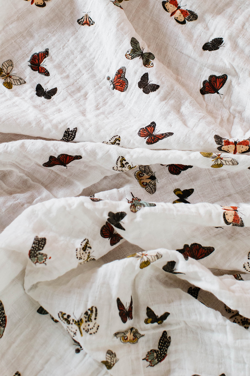 Clementine Kids Butterfly Migration swaddle styled in nursery