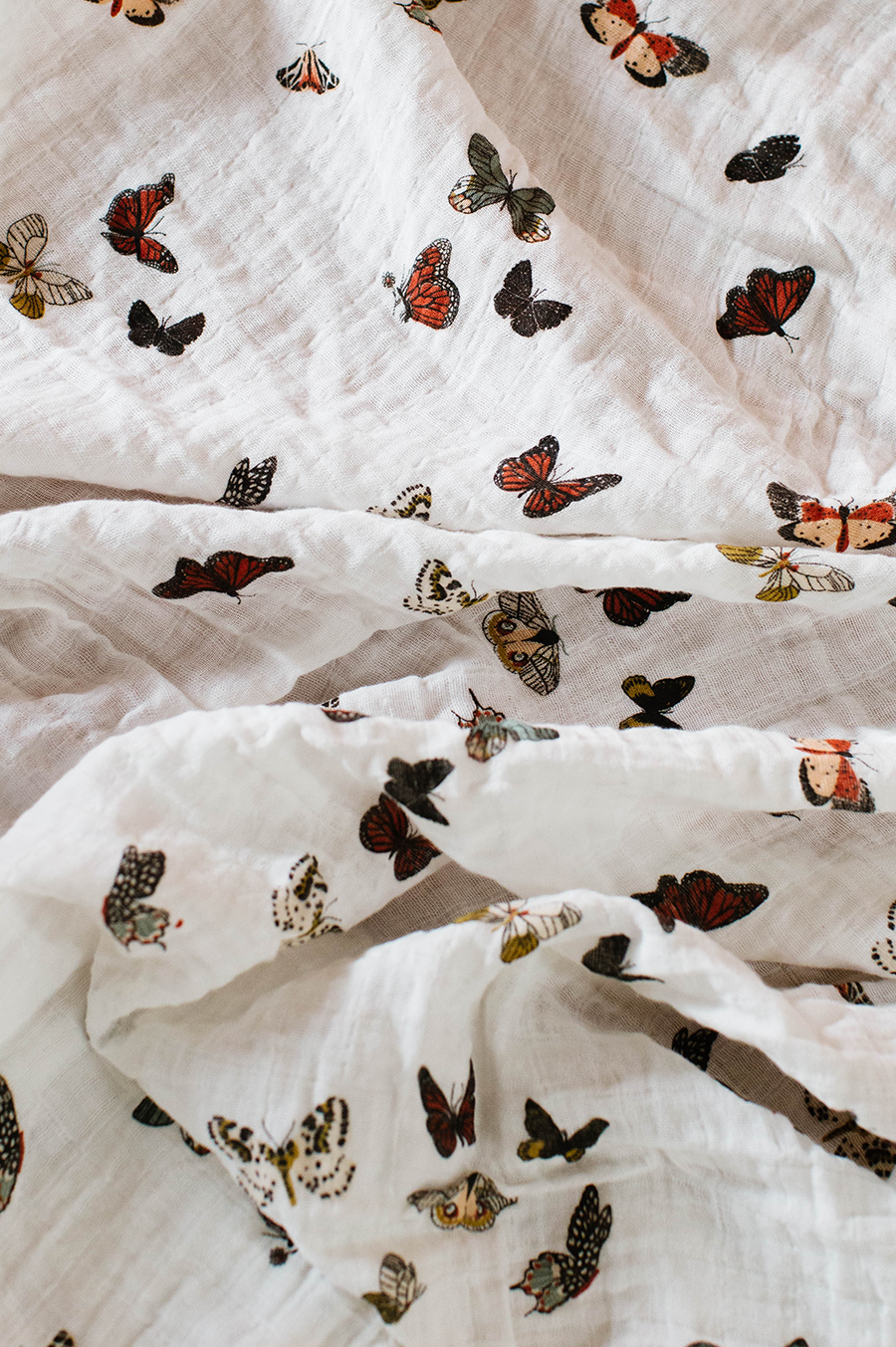 Clementine Kids Butterfly Migration swaddle styled in nursery