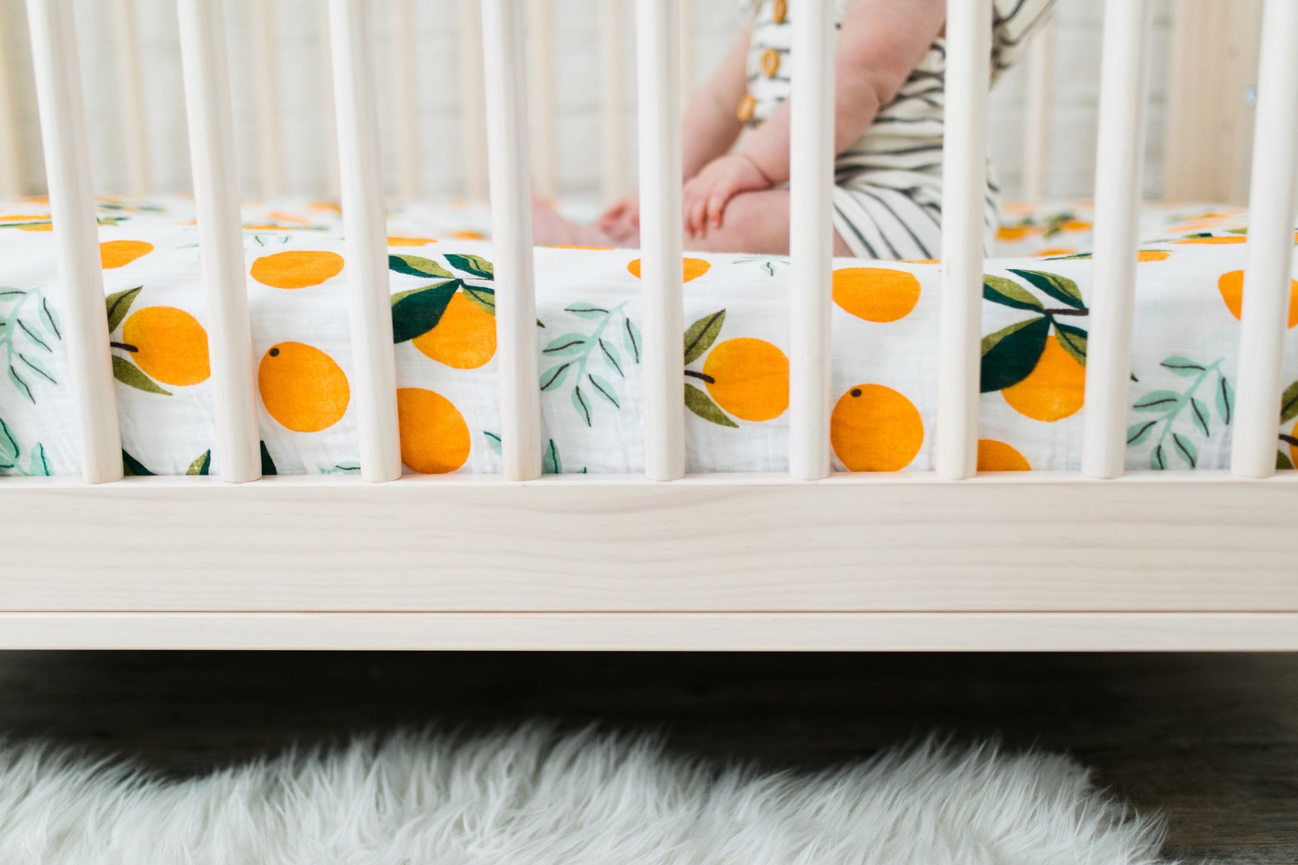 Clementine Kids crib sheet folded neatly with citrus design
