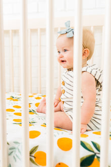 Close-up of breathable muslin fabric with clementine print