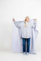 Reversible cotton muslin throw showing floral and periwinkle sides