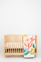 Clementine Kids Cottage Garden Quilt folded on crib