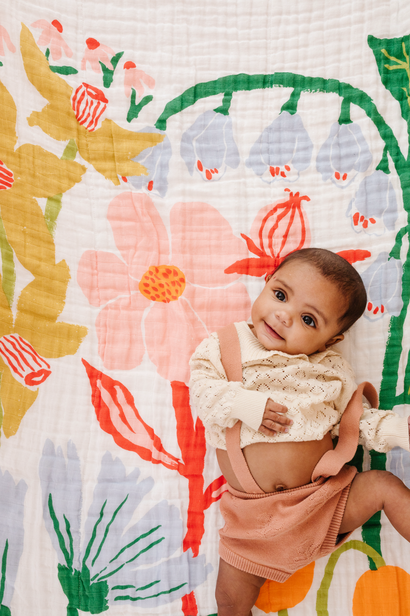Reversible cotton muslin quilt with rainbow floral design