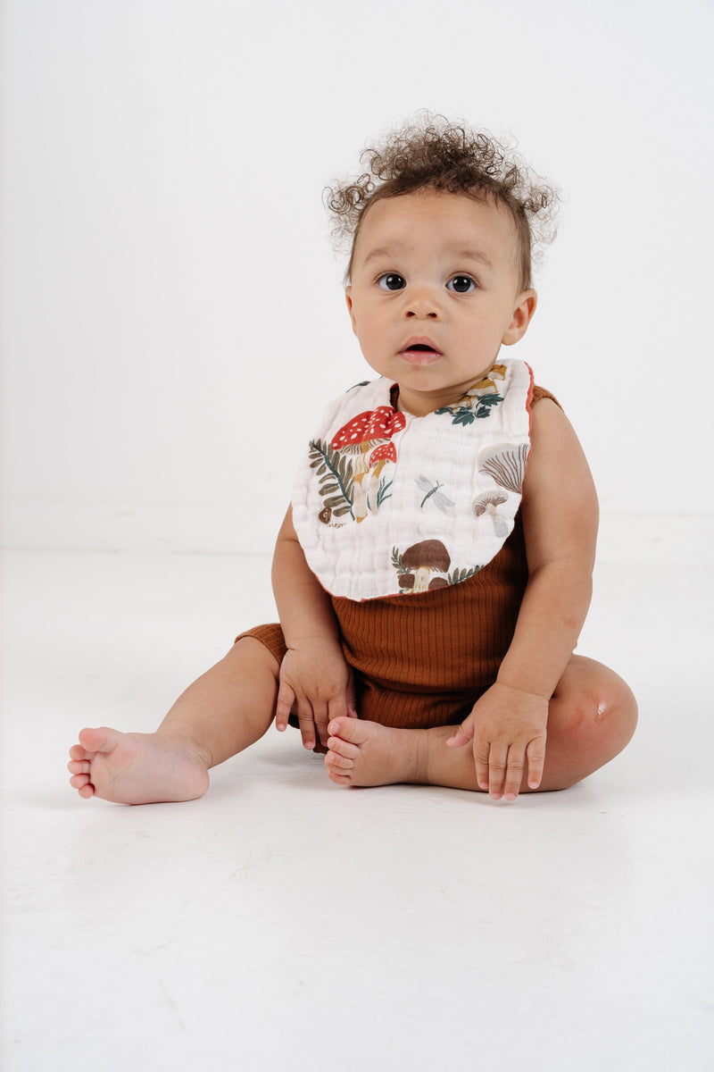 Clementine Kids mushroom bib styled with baby outfit