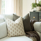 Anais blush block print throw pillow cover on a sofa