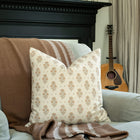 Anais cream and blush floral pillow in a cozy living room