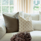 Anais peach floral pillow styled on a sectional sofa