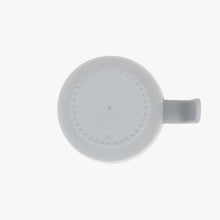 Toddler holding ezpz snack bowl with easy-grip handle