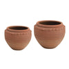 Textured terracotta pot with debossed pattern in red-orange