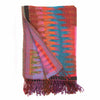 Ikat wool throw with vibrant yarn-dyed pattern styled on sofa