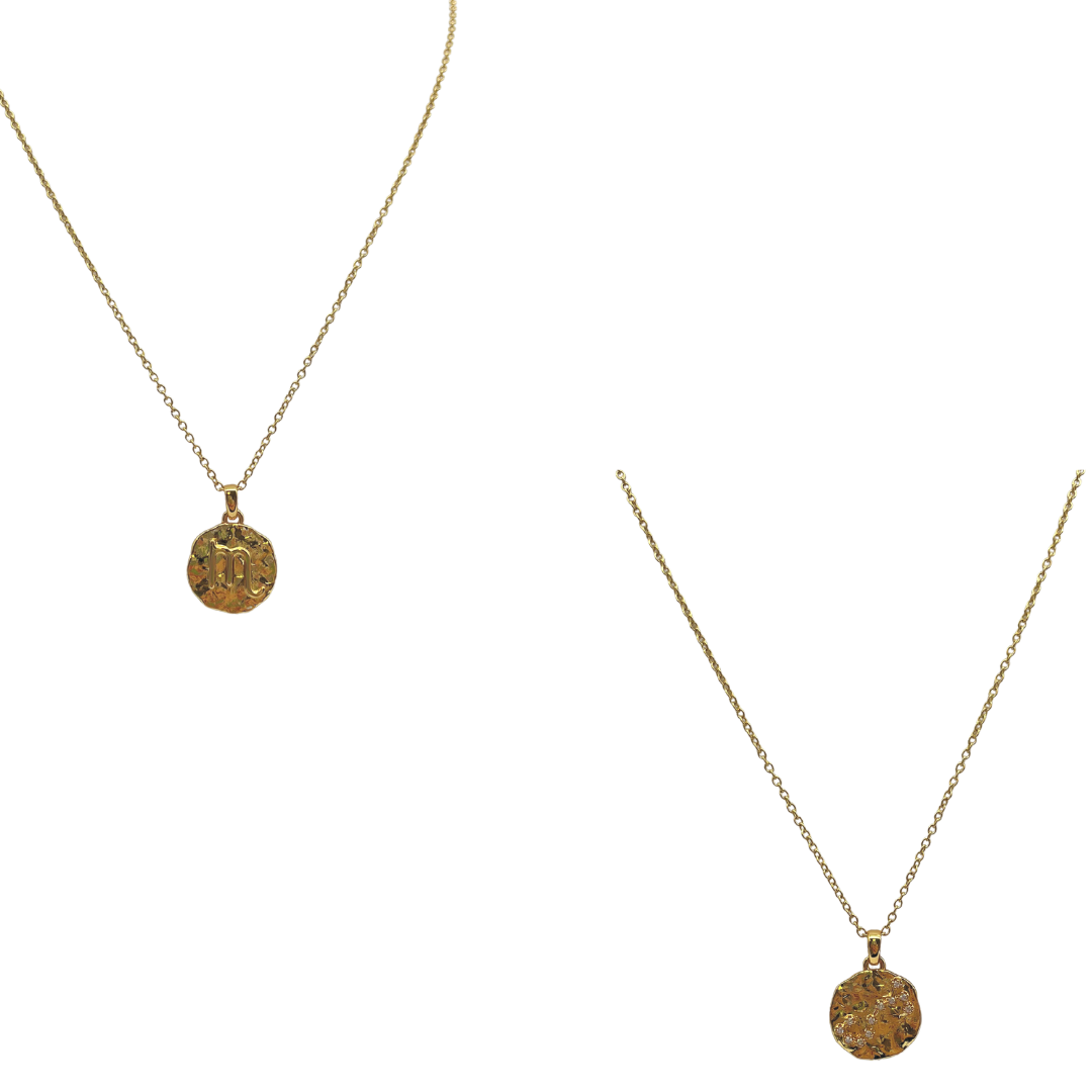 Layered zodiac coin necklace styled with other dainty chains