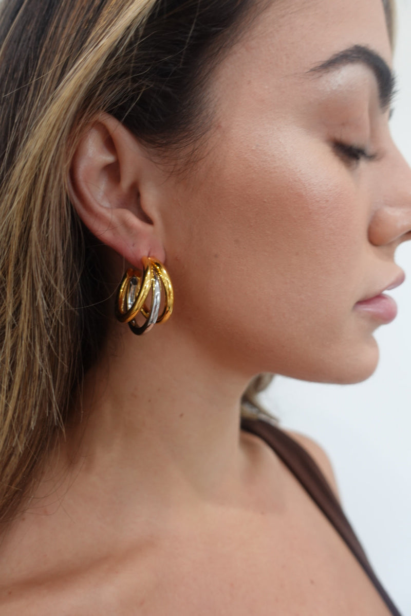 Close-up of tri-hoop silhouette in gold and silver