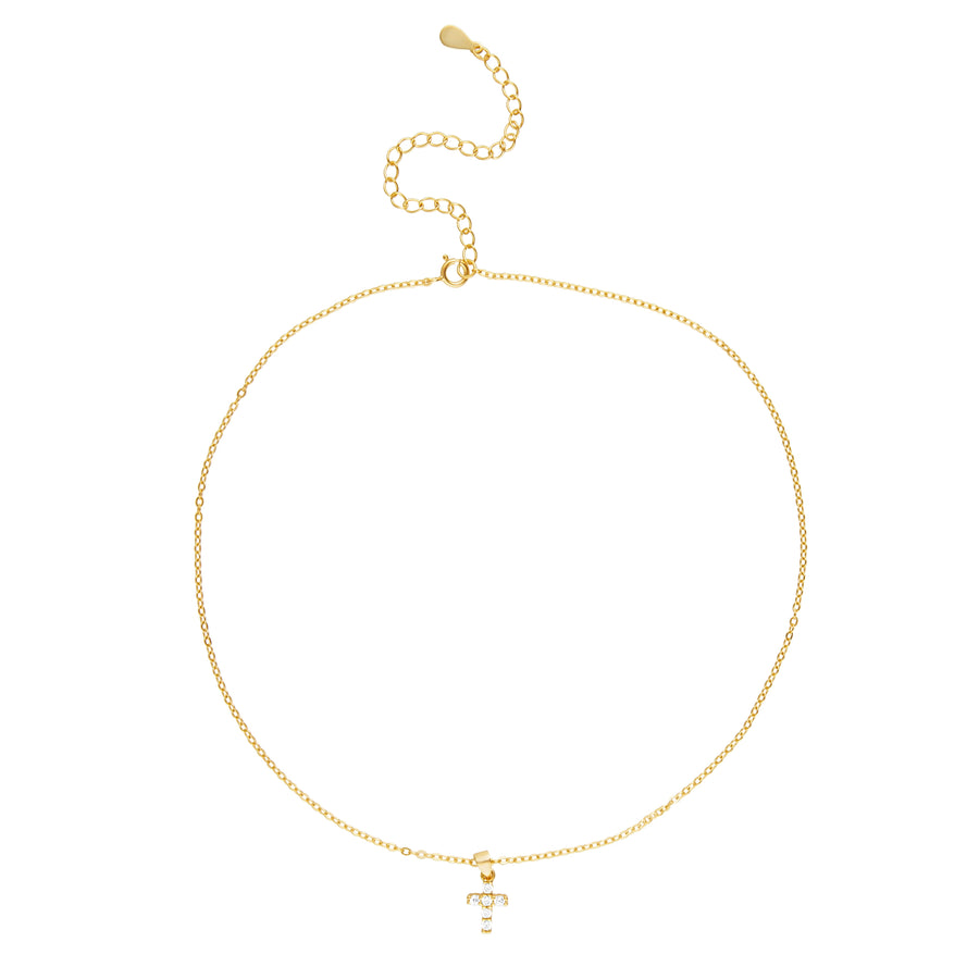 Mini Cross Necklace with dainty gold pendant on display stand