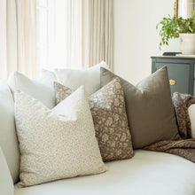 Provence set with ivory ditsy and taupe floral pillows on a sofa