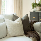 Mila ivory mini floral throw pillow cover on a neutral sofa