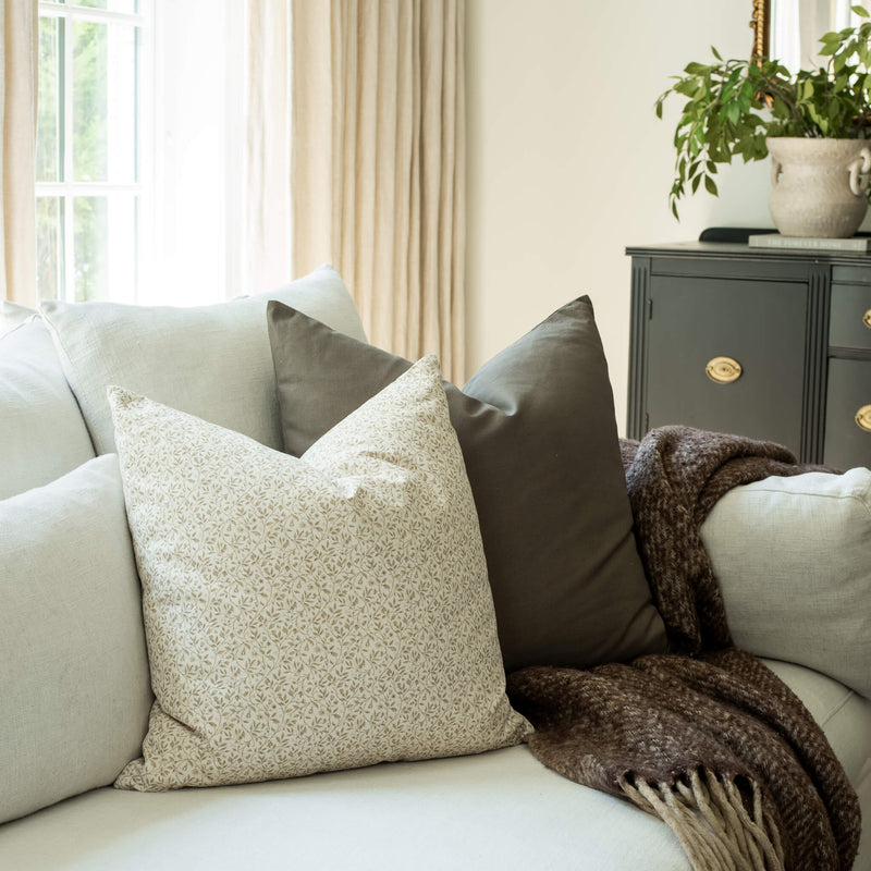 Mila ivory mini floral throw pillow cover on a neutral sofa