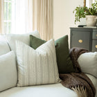 Faye ivory and blue striped throw pillow cover on a sofa