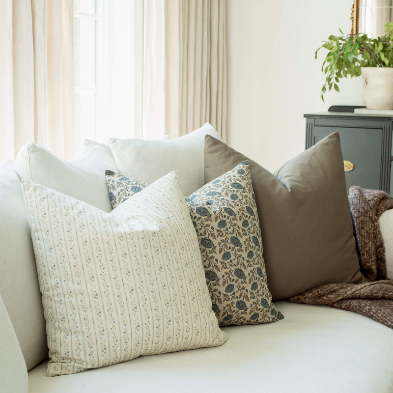 Amelia set with ivory striped and blue floral pillows on a sofa